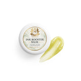 Skin Monarch Ink Booster Balm 30ml, tapa junto a una muestra de bálsamo amarillo brillante